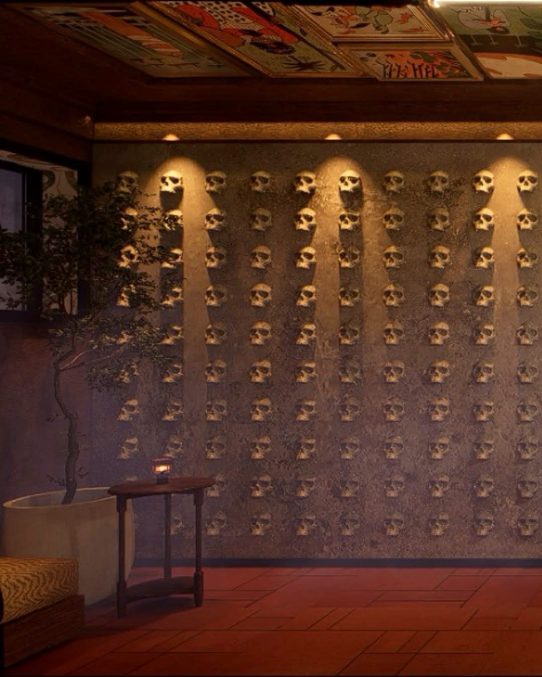 A warmly lit wall of sculpted skulls inside Pablo's